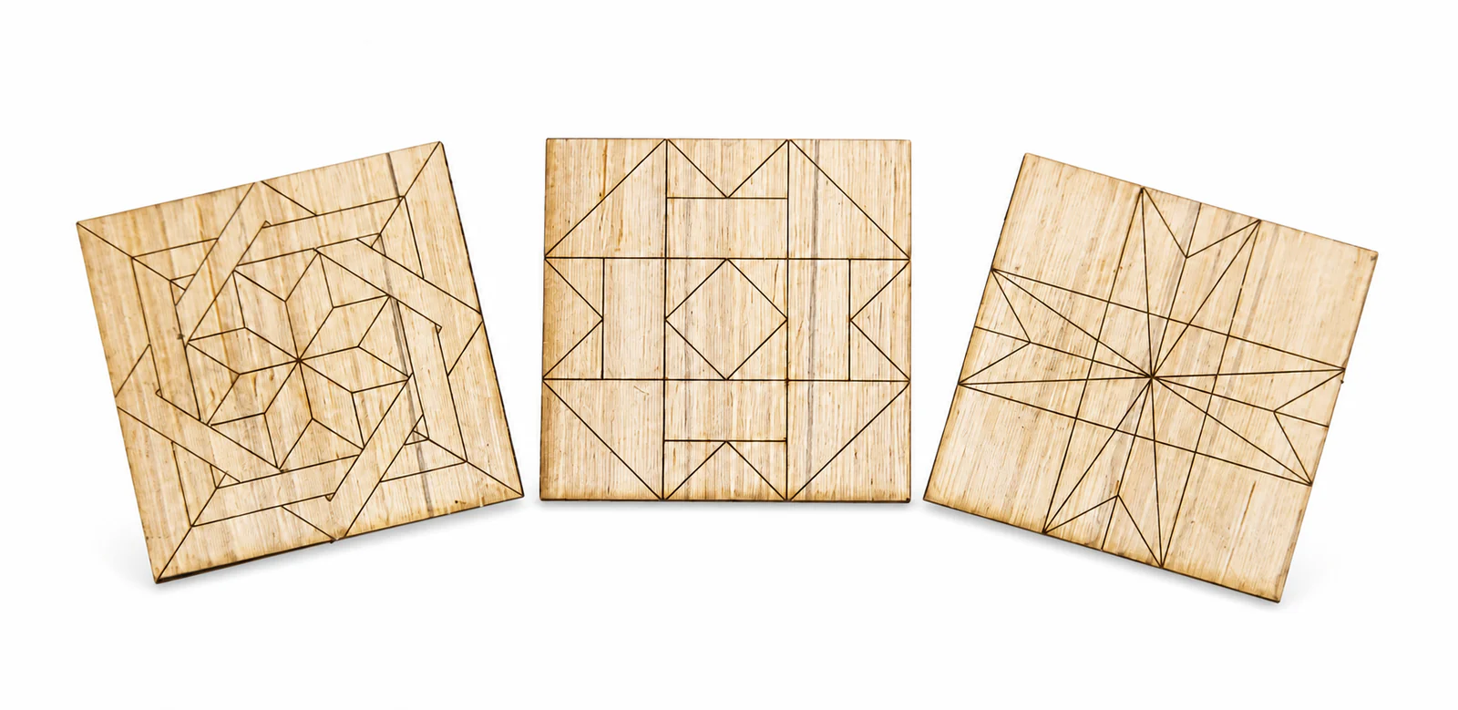 Three examples of unfinished laser-engraved wooden barn quilt blanks